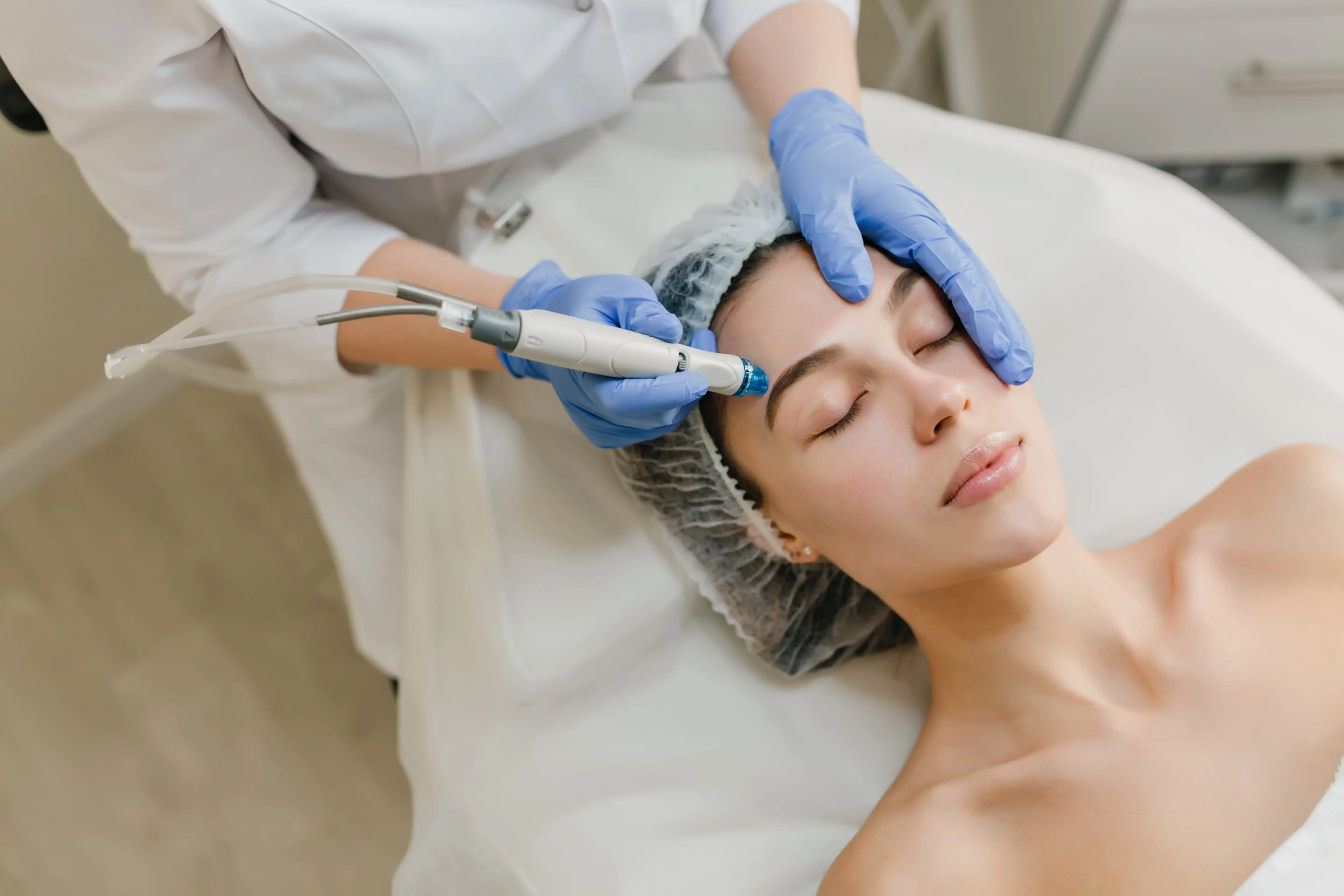 Woman receiving beauty treatments at a salon. Cosmetic rejuvenation and skincare.
